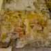 ...e una pittura in cui si intravede Cristo in abito porpora che regge la croce